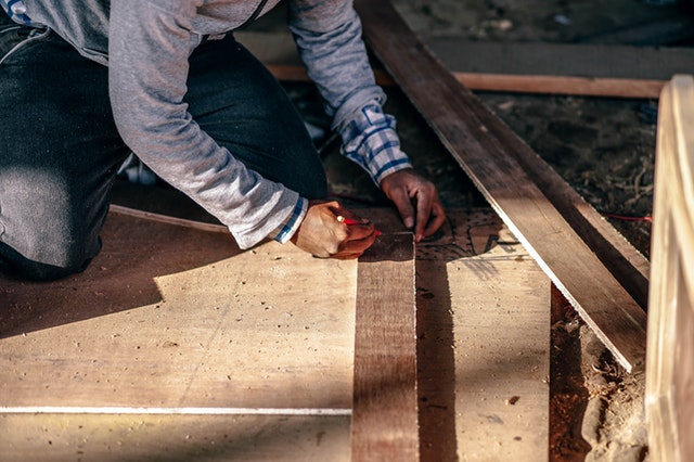 Temporary To Hire Staffing - Person Measuring and Marking Wood